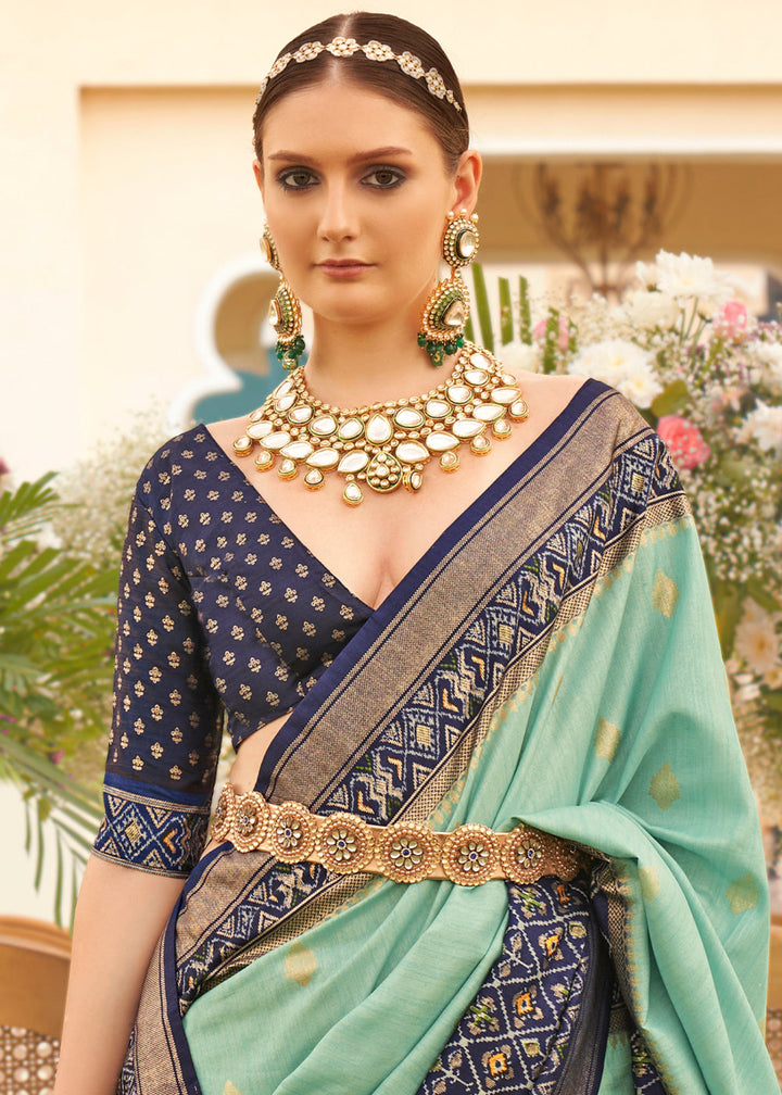  Beautiful handwoven patola silk saree featuring intricate patterns in shades of blue and green