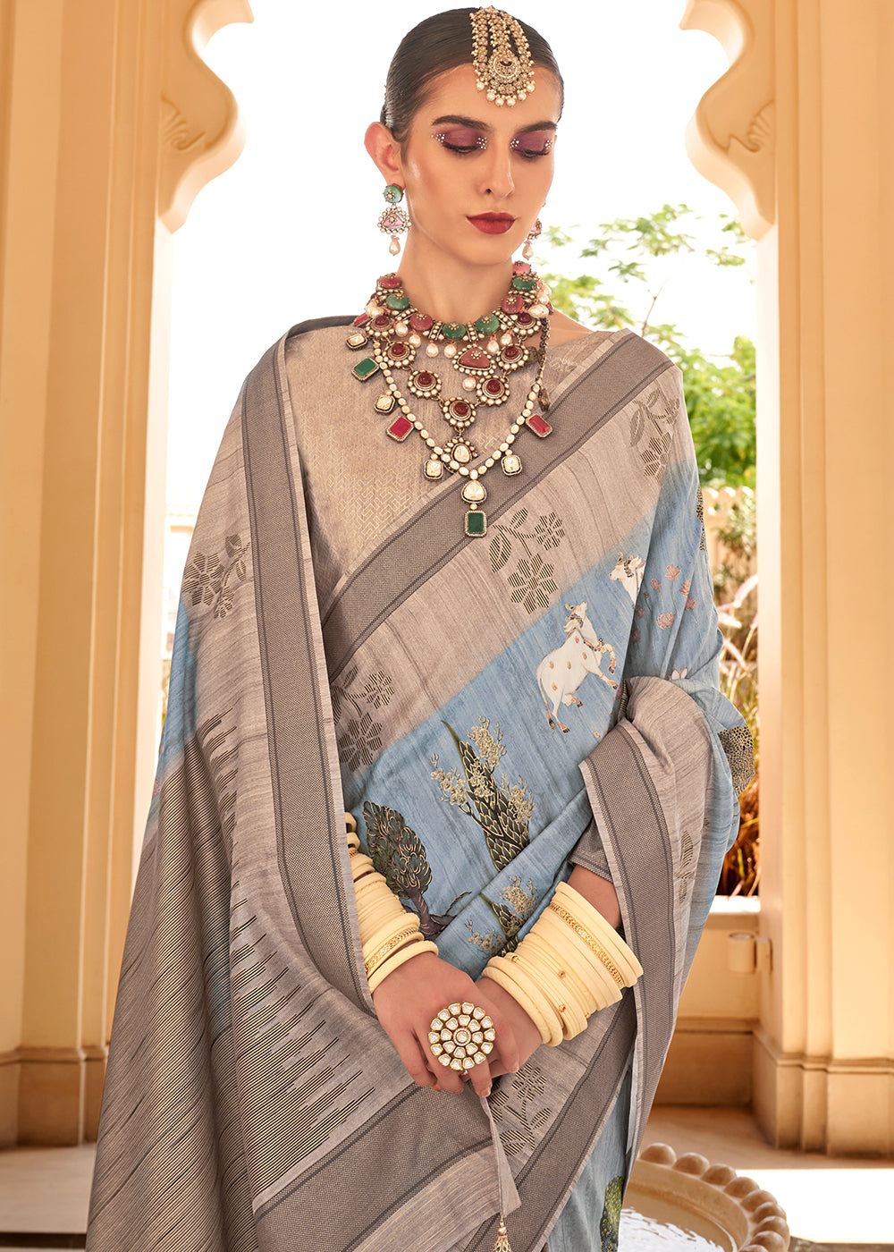 Soft blue Khadi printed raw silk saree with intricate floral patterns and delicate design