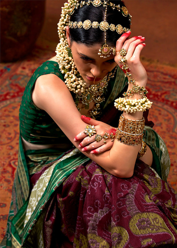 Beautiful purple and green traditional patola printed silk saree with intricate designs