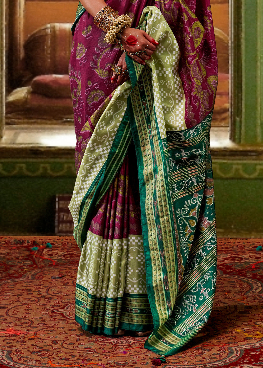 Beautiful purple and green traditional Patola printed silk saree with intricate designs