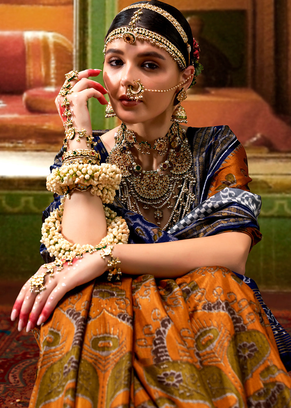 Beautiful orange and blue traditional patola printed silk saree with intricate designs