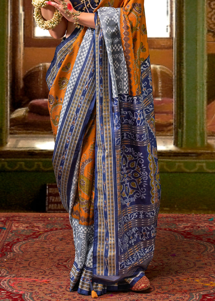 Beautiful handcrafted silk saree in striking orange and blue, featuring traditional Patola print and exquisite craftsmanship, ideal for elegant and traditional attire