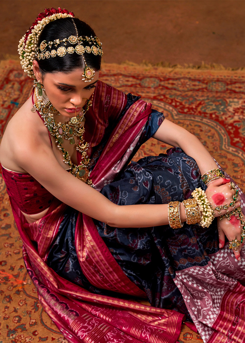 Elegant navy blue silk saree featuring traditional patola print and golden border