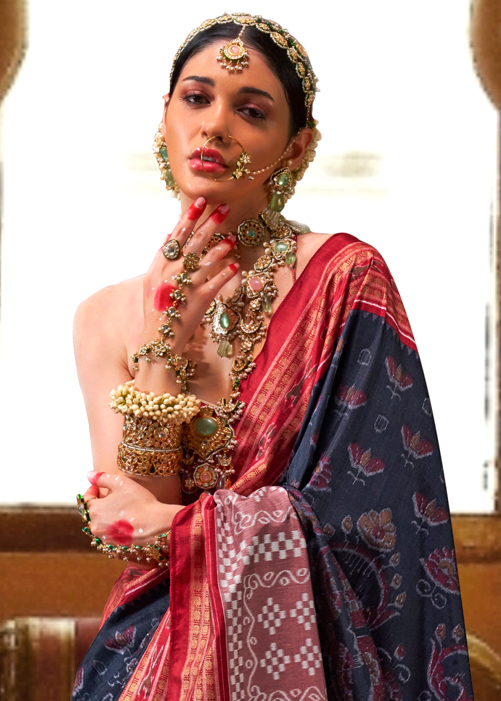 Beautiful silk saree in navy blue with intricate patola print and golden border