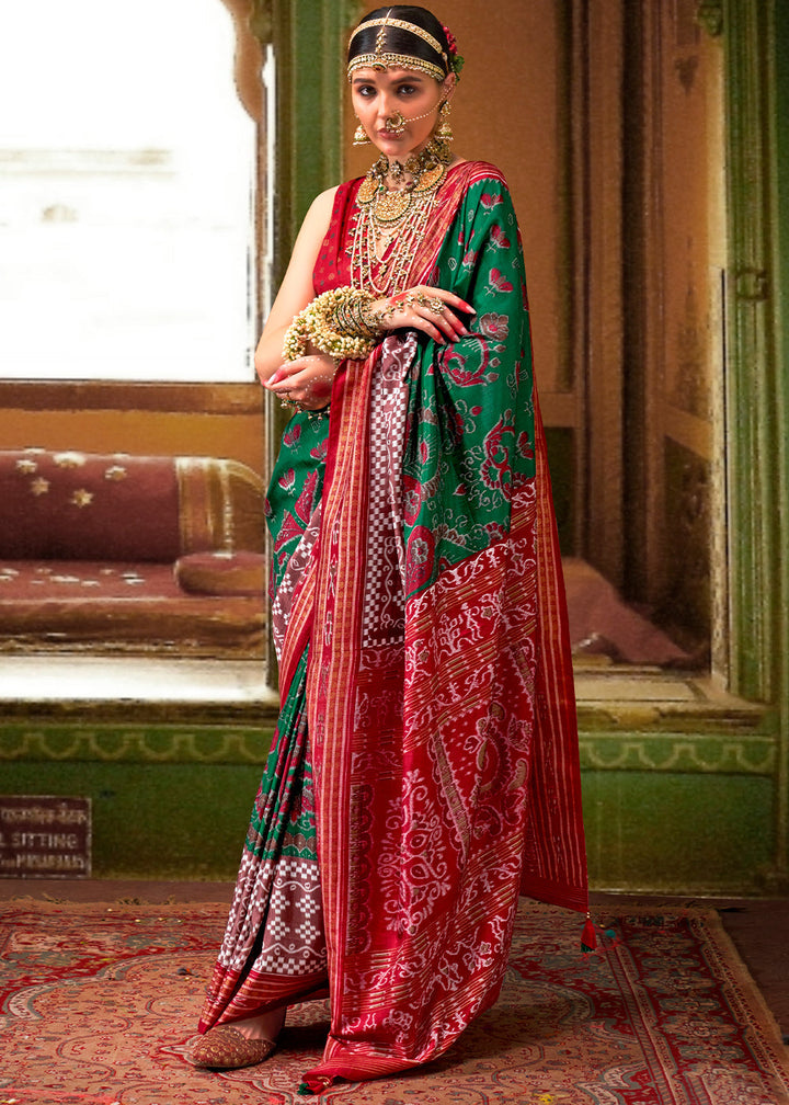 Close-up of intricate traditional Patola print on forest green silk saree