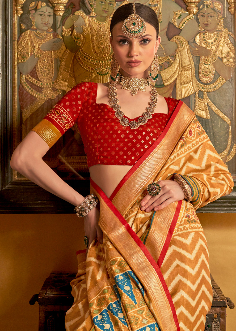 Beautiful shades of brown patola printed silk saree with contrast blouse