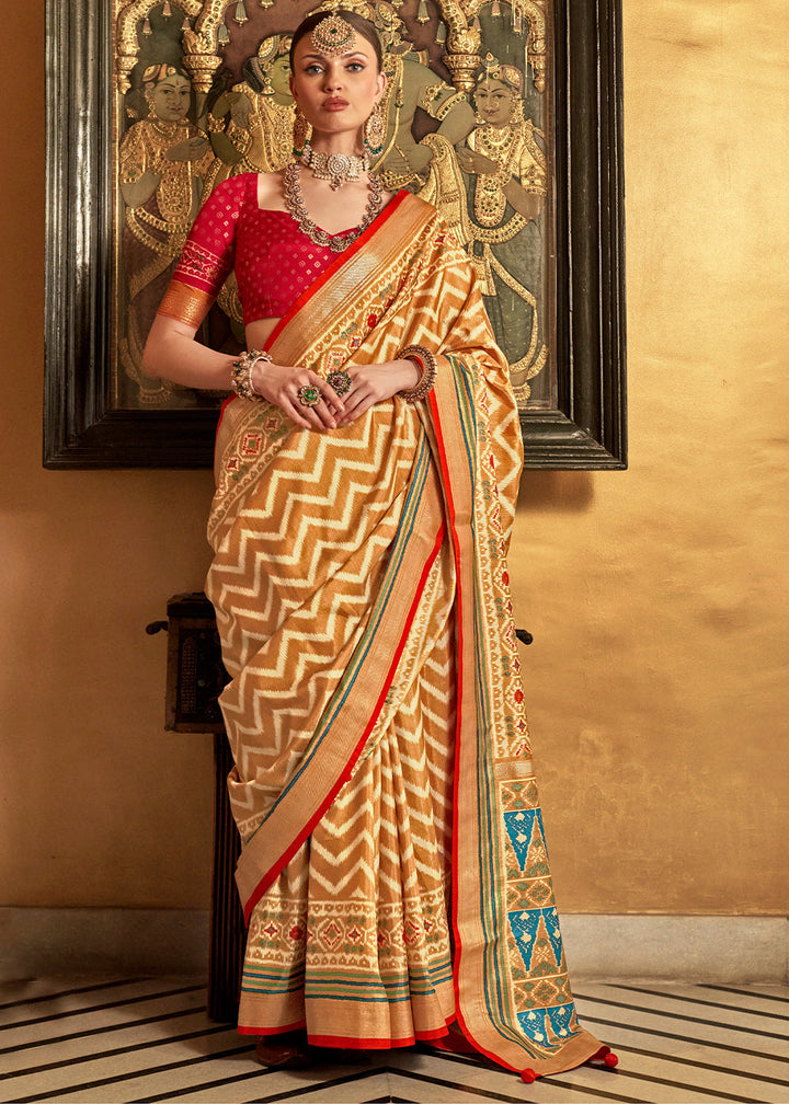 Beautiful patola printed silk saree in shades of brown with contrasting blouse