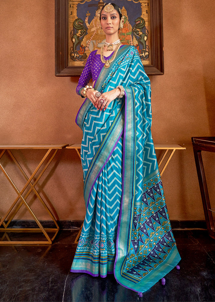 Cerulean blue patola printed silk saree with contrast blouse, traditional Indian attire showcasing intricate design and vibrant colors