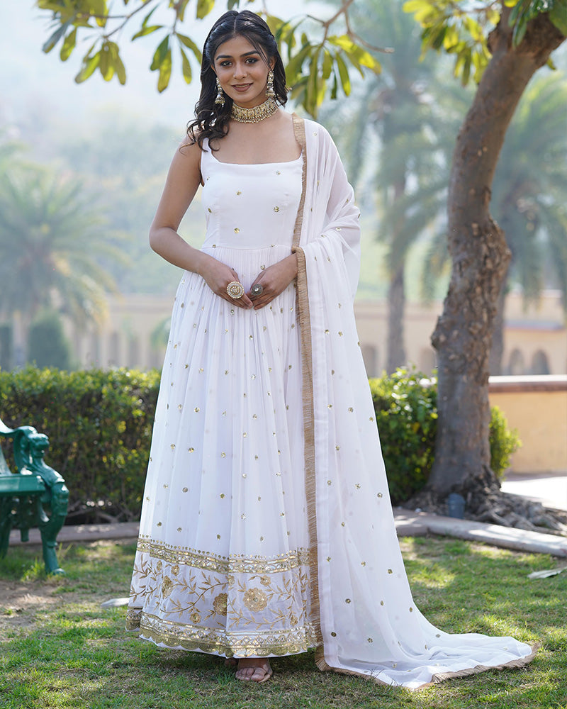  Exquisite white color gown adorned with intricate embroidered work and a flowing silhouette, designed by Qivii