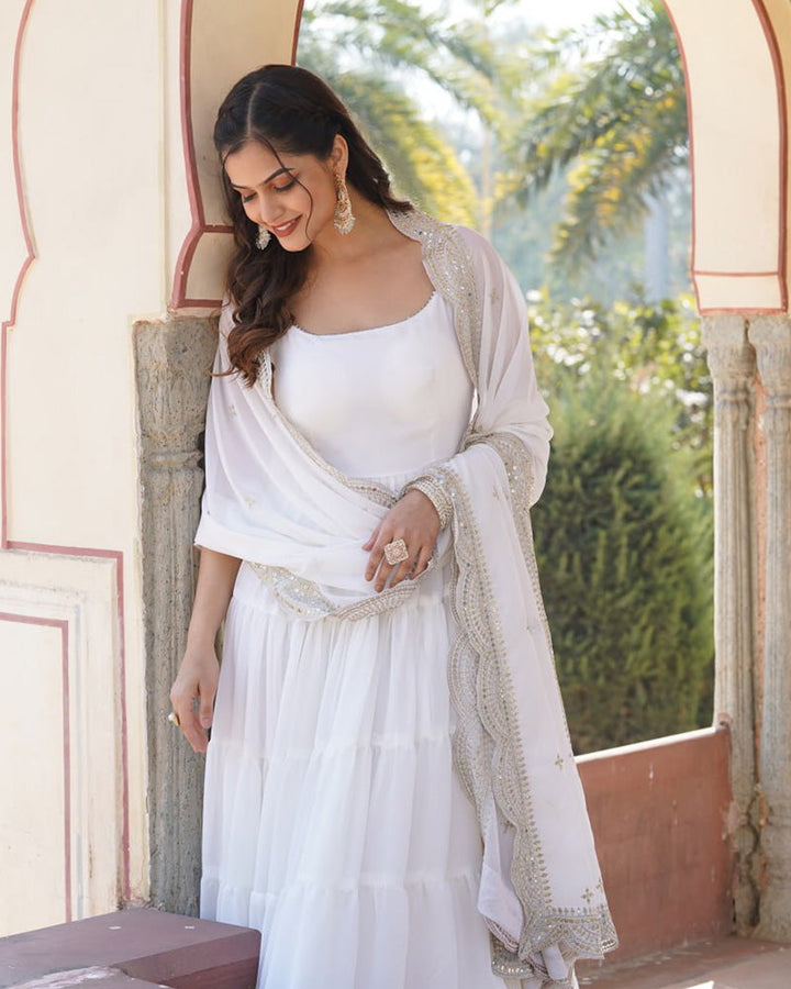 Beautiful designer white floor-length gown with frill detailing and matching dupatta by Qivii, perfect for special occasions and formal events