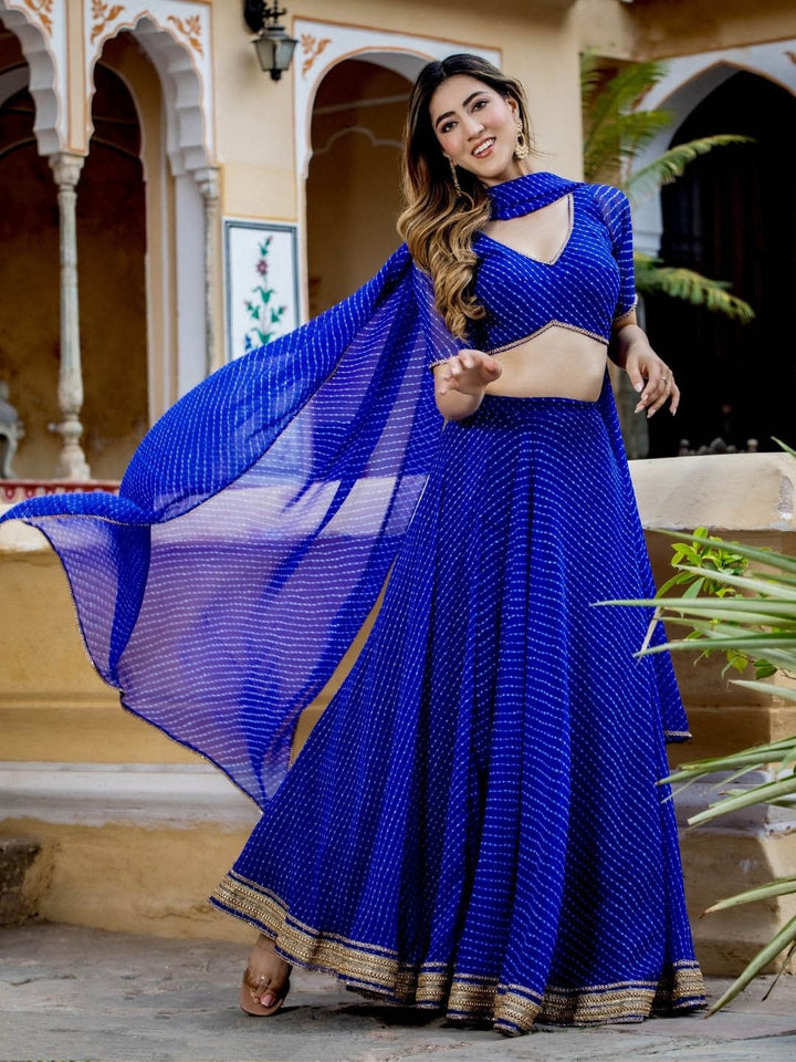 Blue color georgette lehenga with intricate zari and cording lace work, featuring leheriya print design