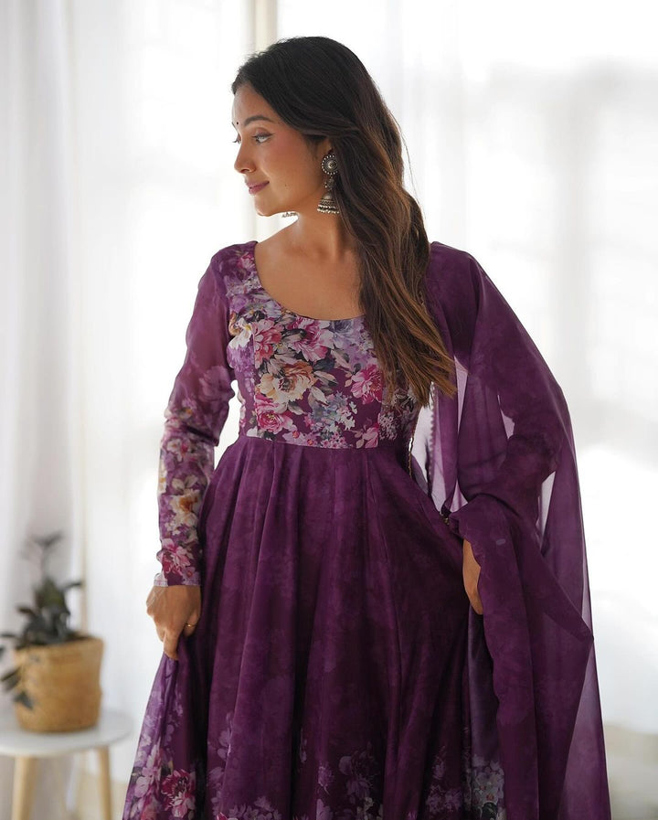 The wine color floral print organza three-piece anarkali suit by Qivii is elegantly displayed in this image, highlighting its intricate details and timeless beauty