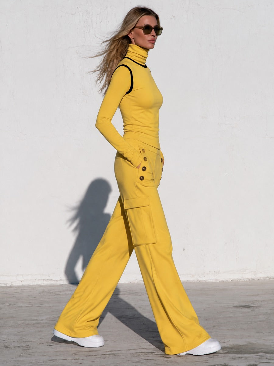 Yellow women's turtleneck long-sleeved top paired with black trimmed cargo pants, stylish outfit by Oyrosy Clothing.
