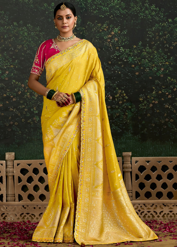 Beautiful yellow and magenta zari silk saree with intricate embroidery and traditional design