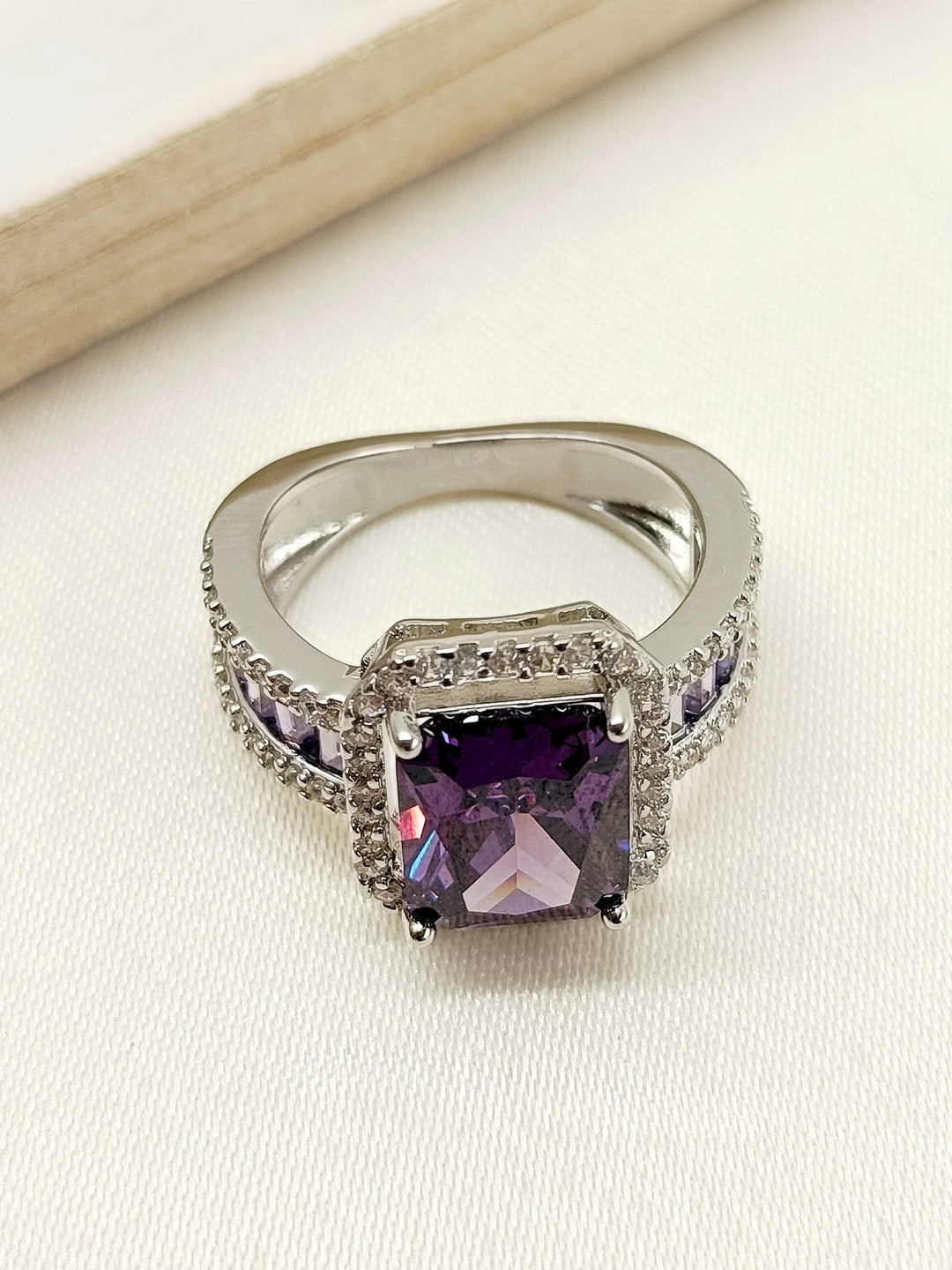 Close-up of the stunning Deepti Purple American Diamond Finger Ring on a woman's hand