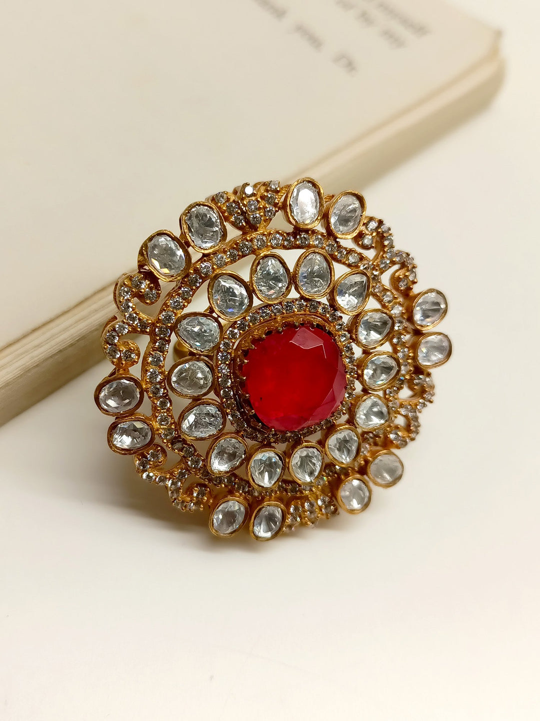 A close-up image of a Vanshika Red Victorian Finger Ring, featuring intricate detailing and a classic, elegant design