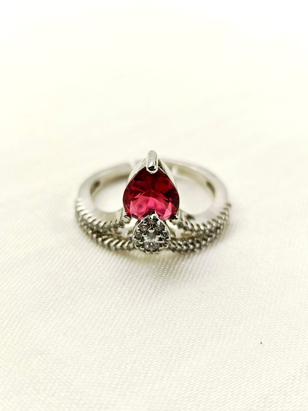  Beautiful Zufra Maroon American Diamond Finger Ring with a maroon stone set in silver, on a white background