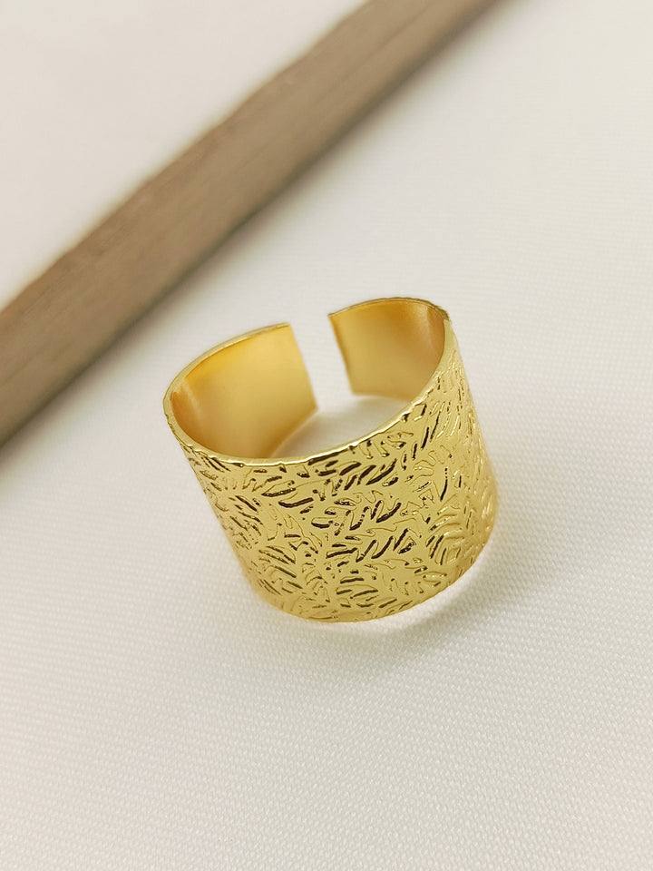 ###
A close-up image of Nicika Golden Western Finger Ring with intricate design and shiny finish