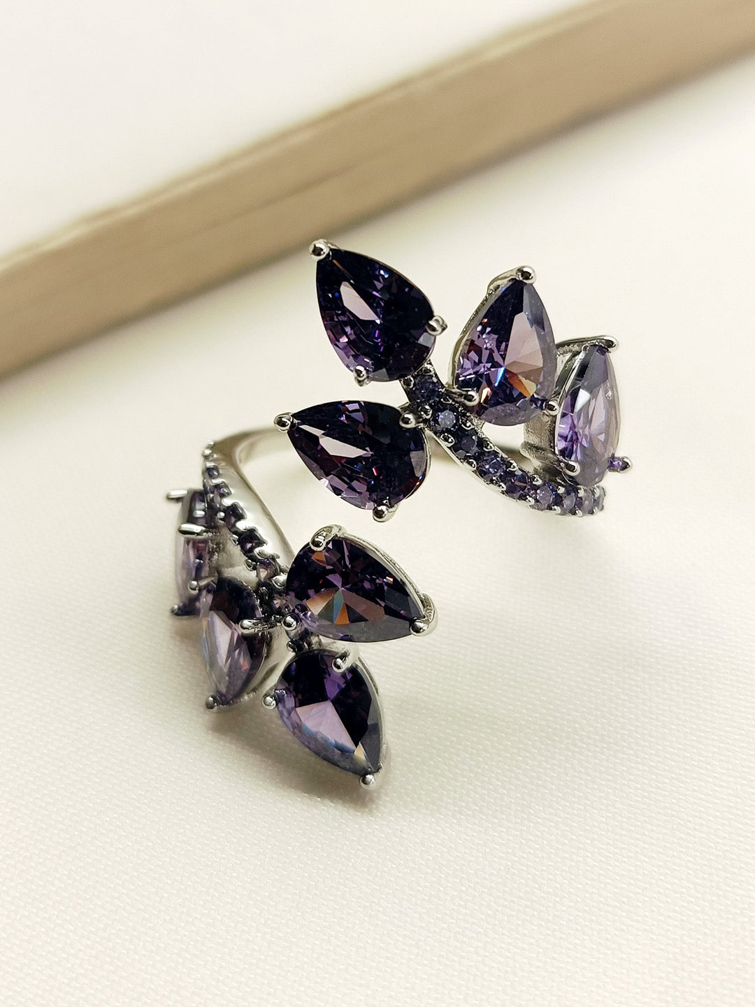 Close-up image of Divi Purple American Diamond Finger Ring with intricate silver design and vibrant purple gemstone for elegant and stylish look