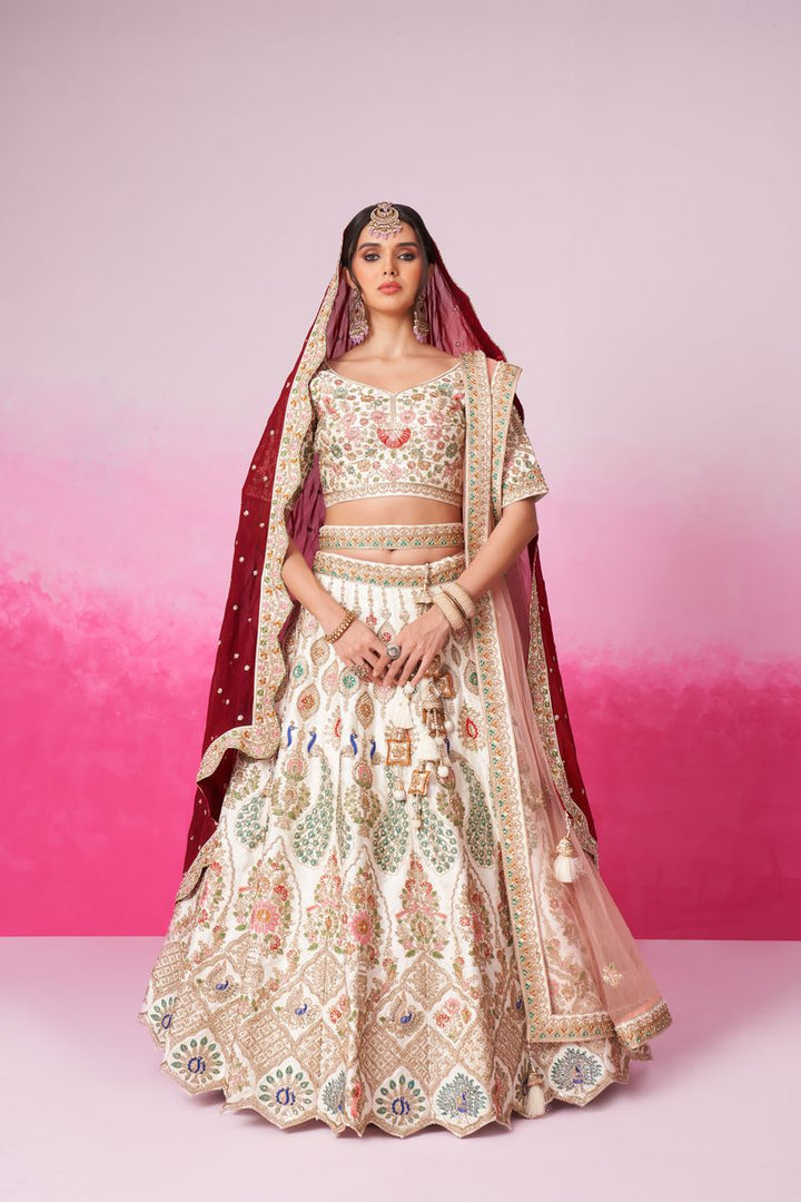 Cream silk lehenga with intricate embroidery and double dupatta