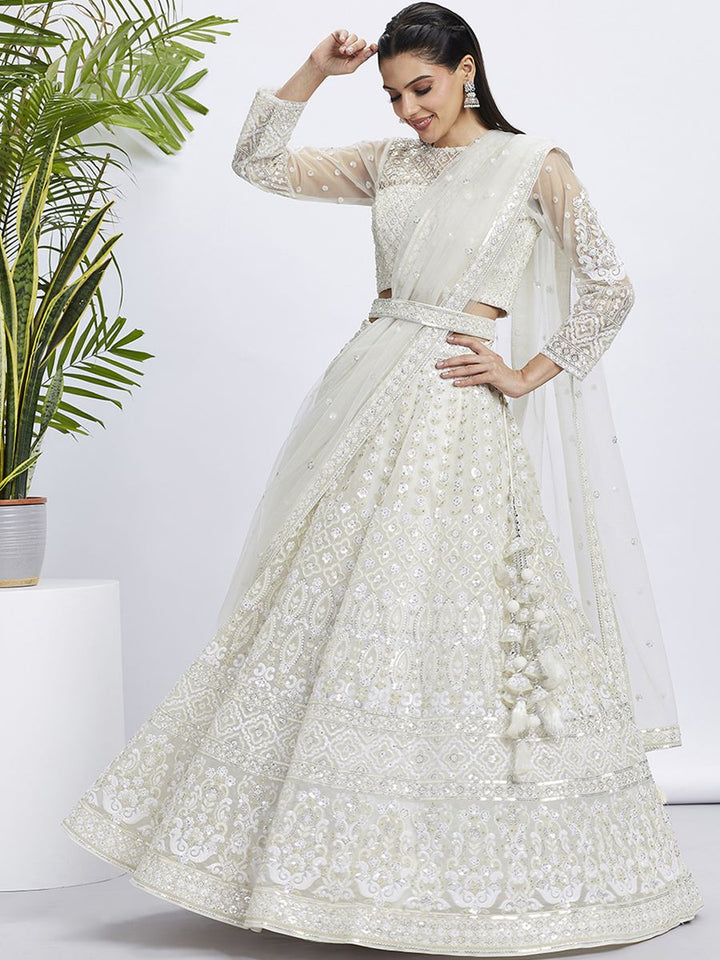 Cream white color sequined and heavy embroidered net semi-stitched lehenga choli front view on mannequin