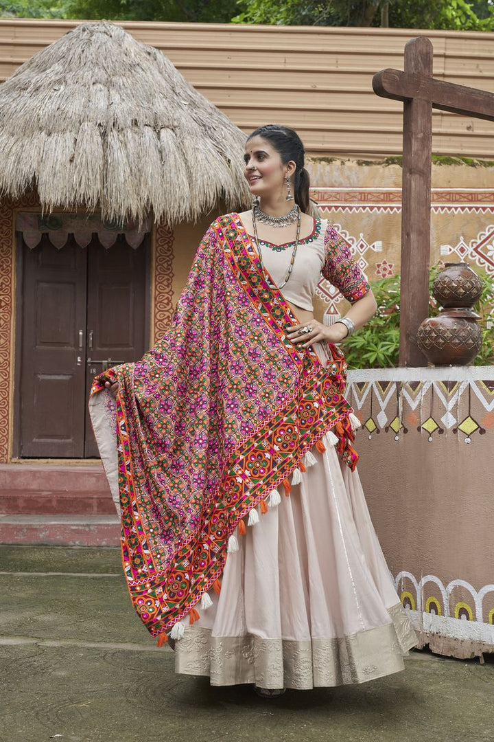 Beige color viscose rayon lehenga with intricate embroidered work and mirror detailing