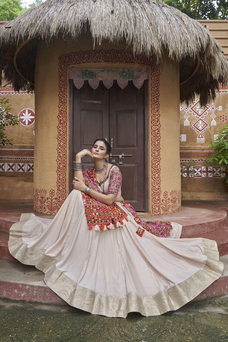 Gorgeous beige viscose rayon lehenga adorned with intricate embroidery and all over mirror work