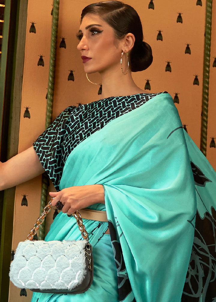 Alt text: Elegant turquoise blue designer satin crepe printed saree with intricate floral patterns