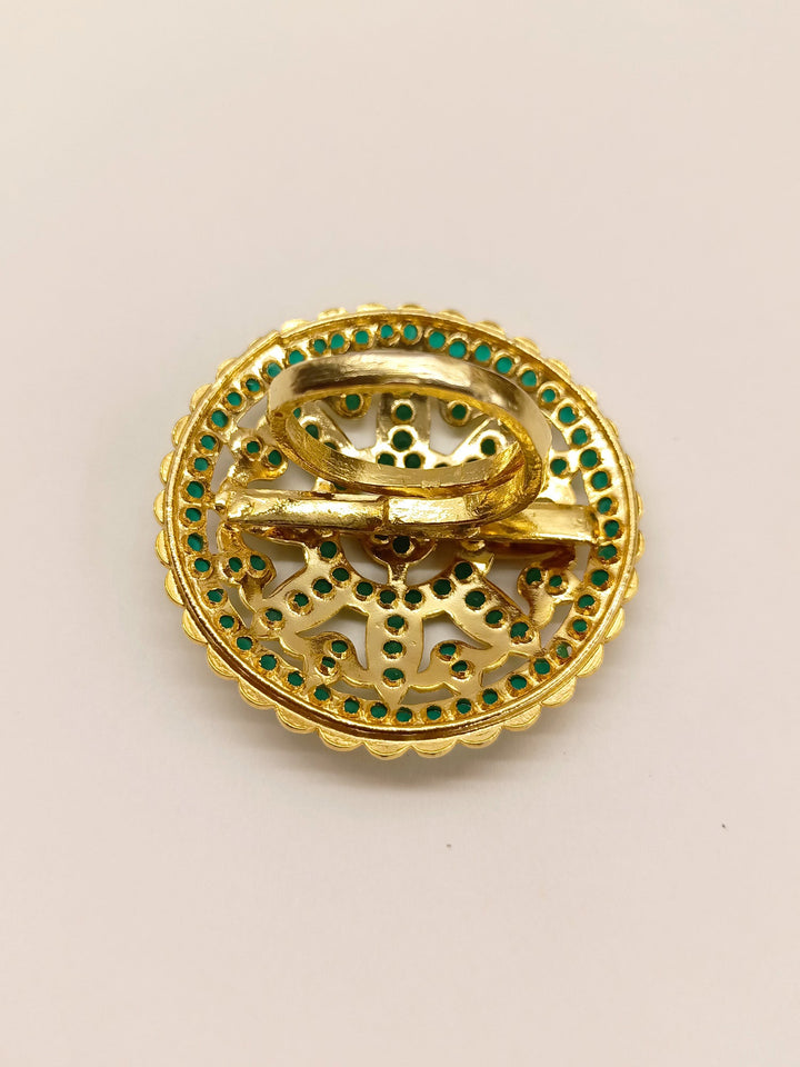 Gold finger ring with intricate green jadau work and sparkling gemstones