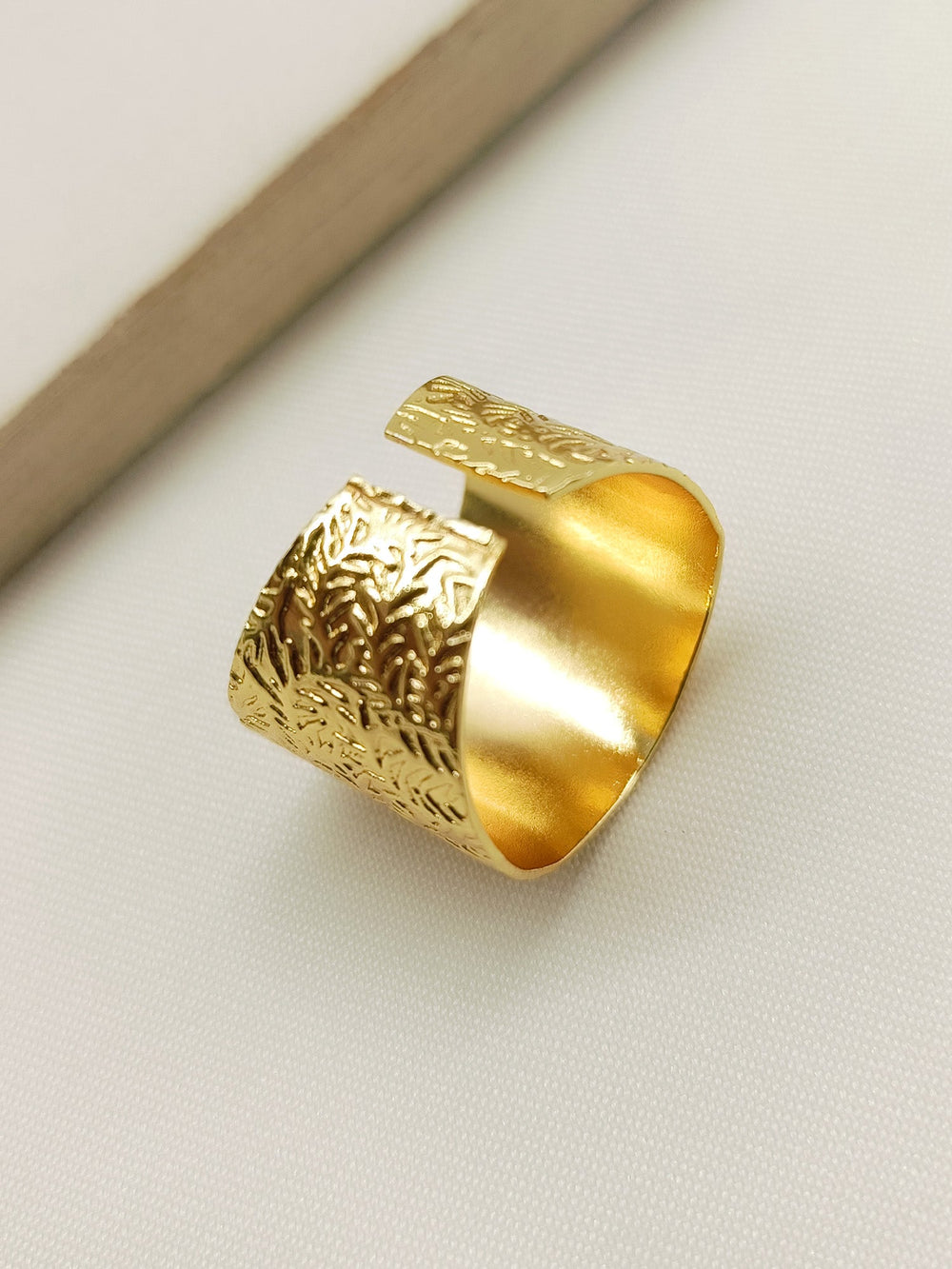 A hand wearing Nicika Golden Western Finger Ring, showcasing its elegant and stylish look