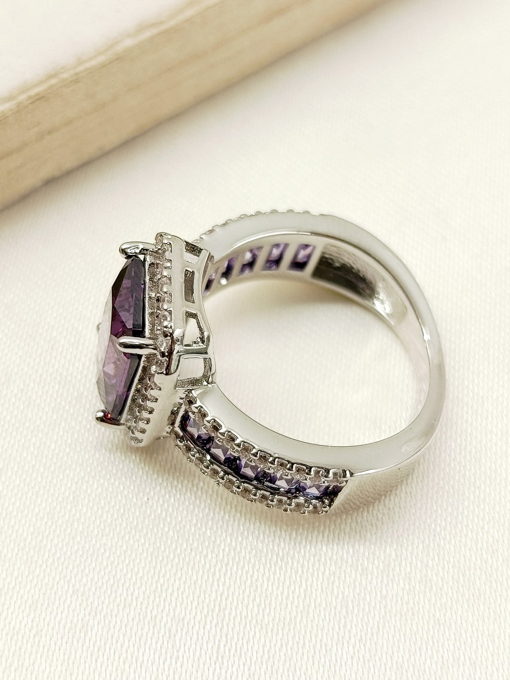 Beautifully crafted Deepti Purple American Diamond Finger Ring shining in the light