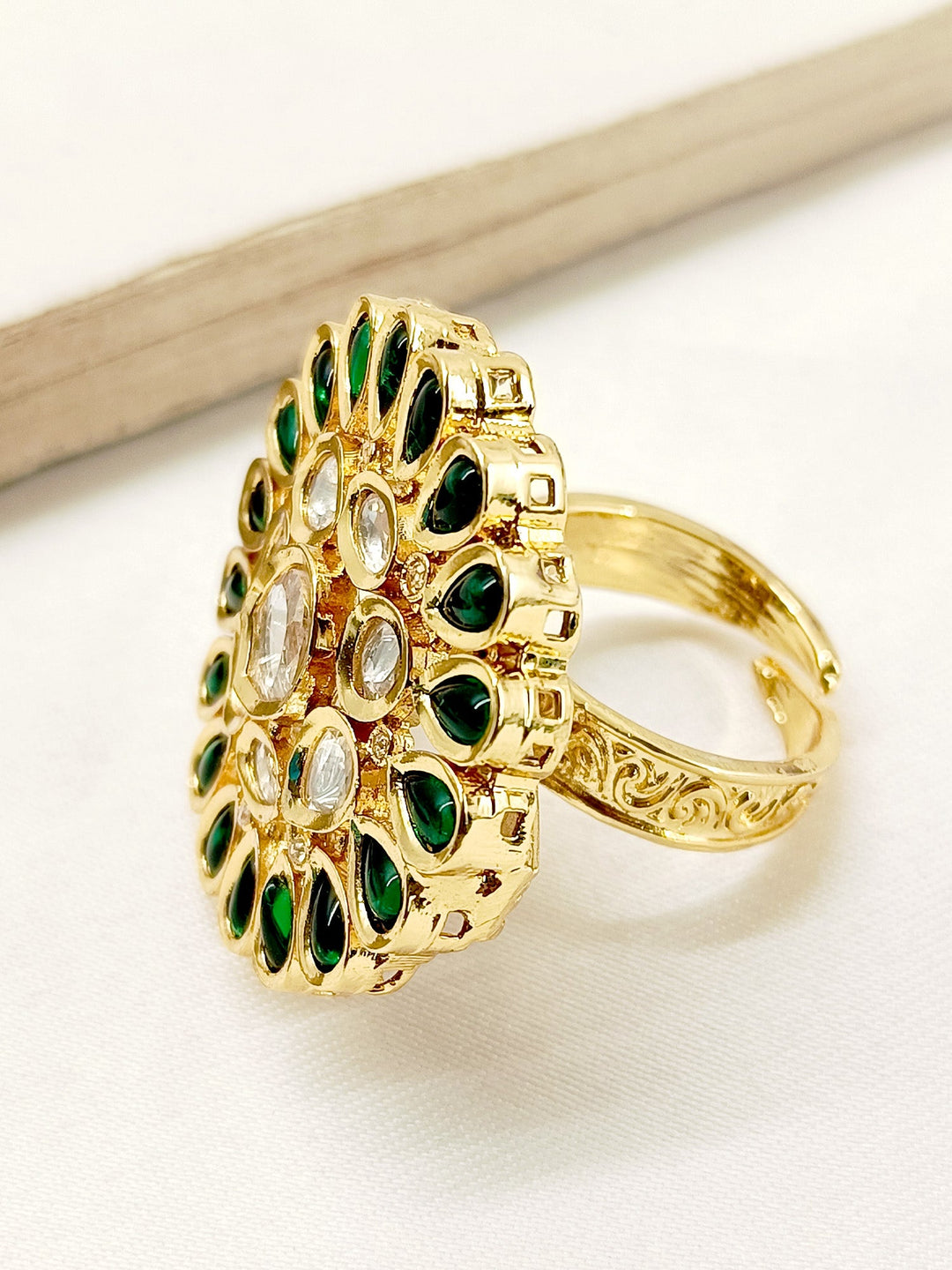 Close-up of a woman's hand wearing the Nima Green Kundan Finger Ring, highlighting the beautiful craftsmanship and elegant design