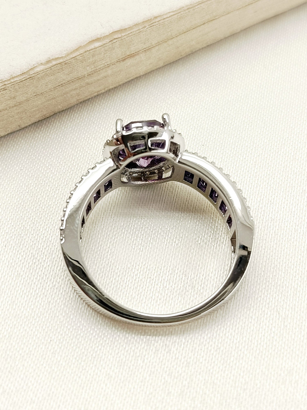 Dazzling Dimple Purple American Diamond Finger Ring with Silver Band and Intricate Detailing