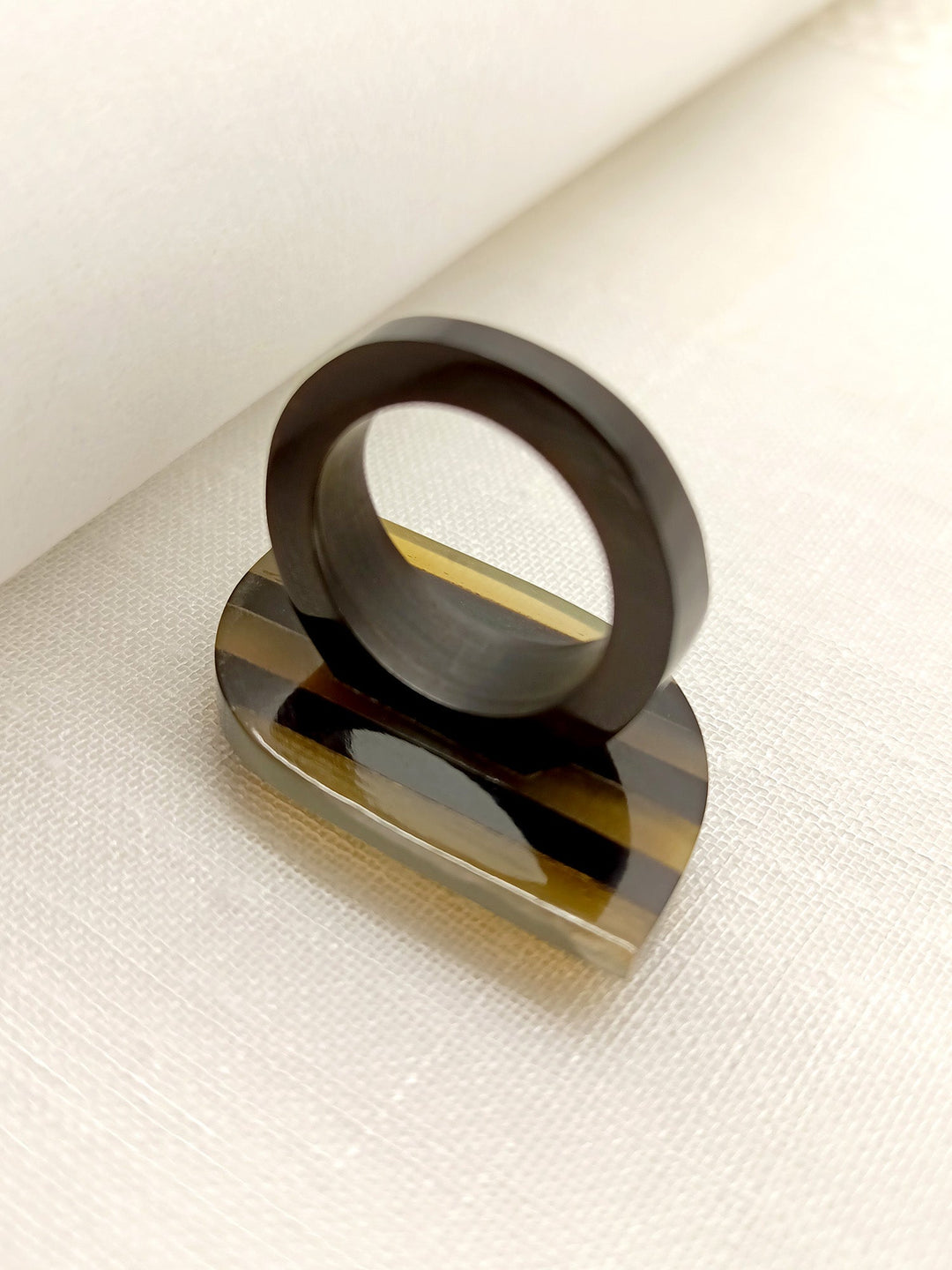  Handcrafted Garima Beige Squircle Shape Acrylic Finger Ring displayed on a marbled surface