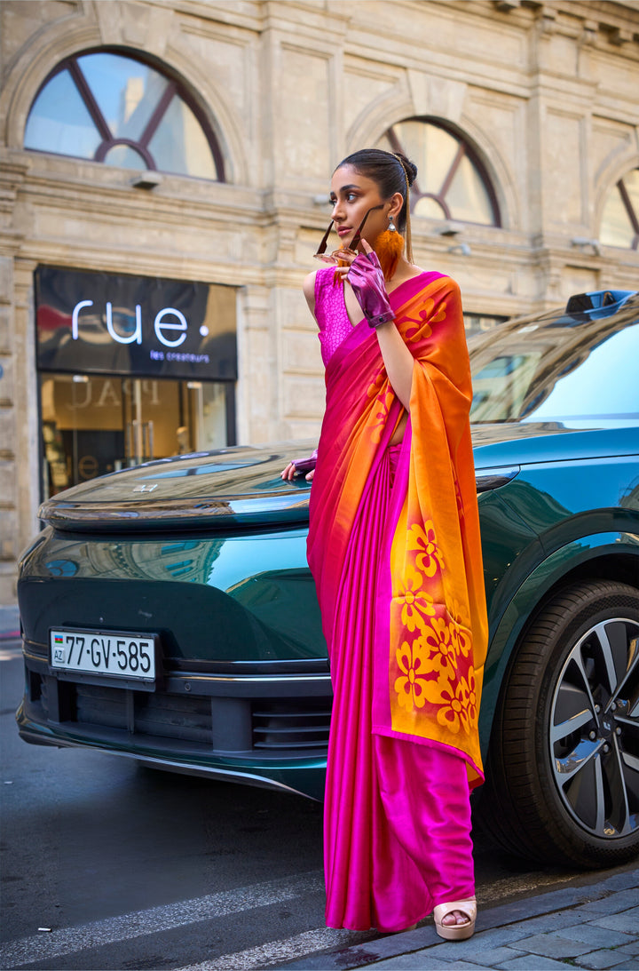 Pink and orange color satin crepe print saree with floral design and golden border