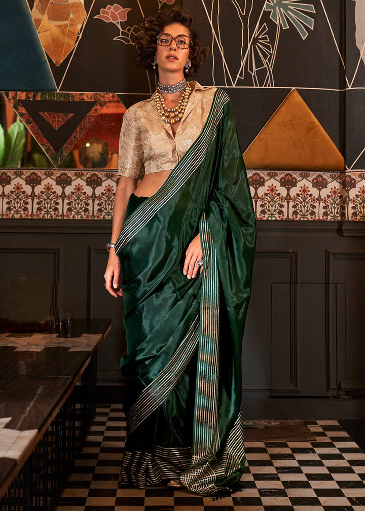 Close-up image of Sacramento Green Handloom Woven Viscose Satin Saree with intricate patterns and contrasting blouse on a mannequin 