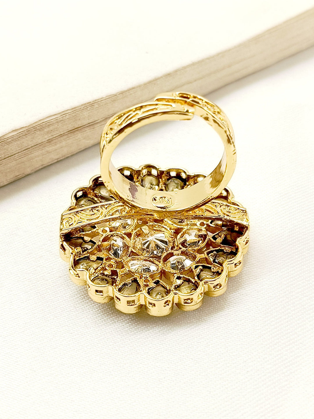 Traditional Indian finger ring with green Kundan stones and gold accents