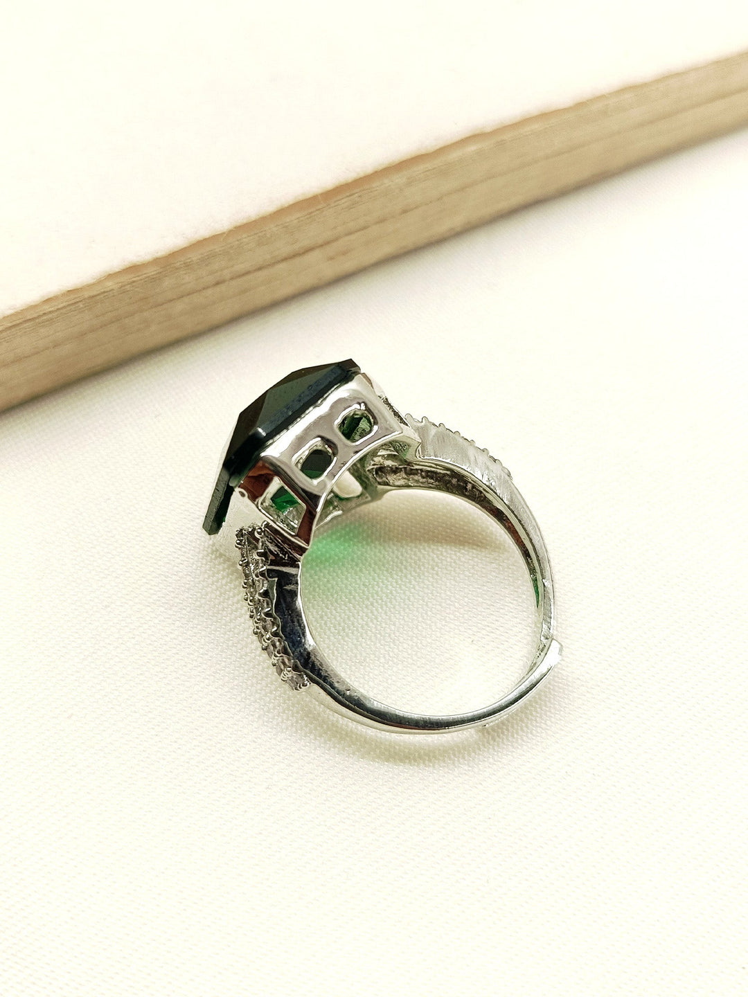 Alt text: Shiny Eliana Green American Diamond Finger Ring with intricate floral design