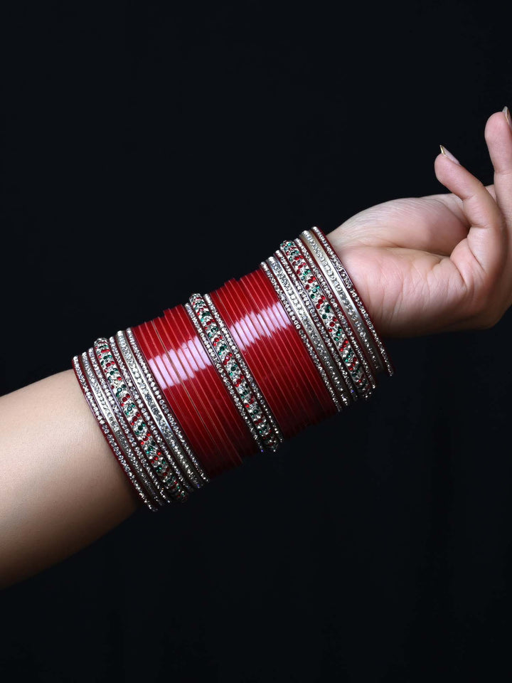 Punjabi chura set featuring intricate gold and red bangles with embellishments 