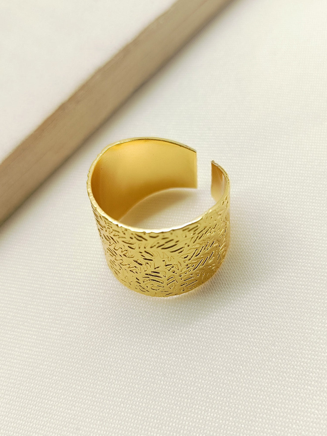 Nicika Golden Western Finger Ring displayed on a jewelry stand, highlighting its luxurious and timeless design
###