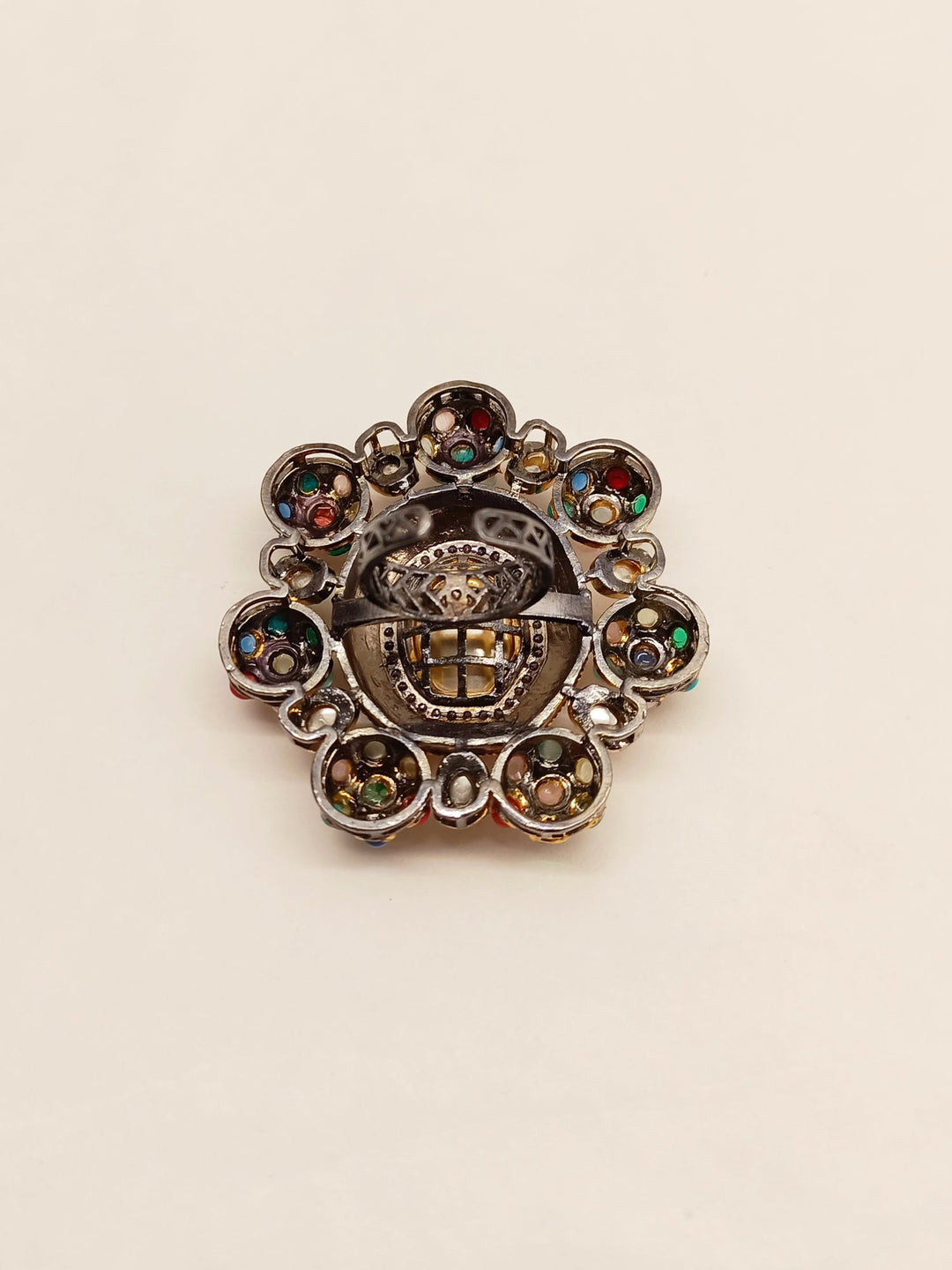 Beautiful gold Victorian finger ring adorned with nine gemstones in the traditional Navratna style