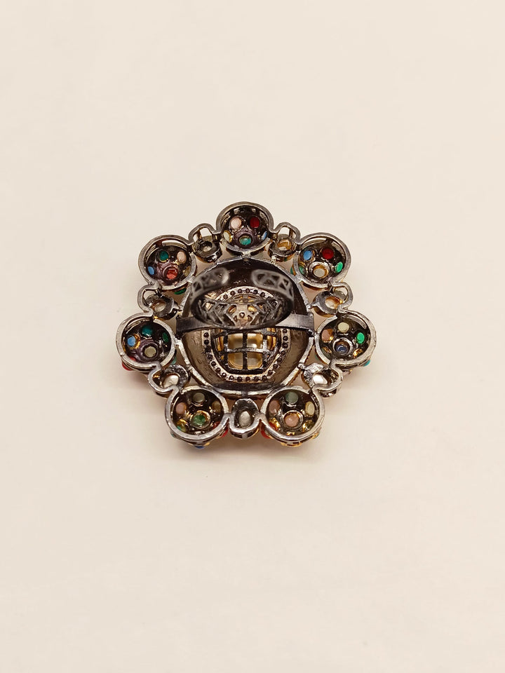 Beautiful gold Victorian finger ring adorned with nine gemstones in the traditional Navratna style