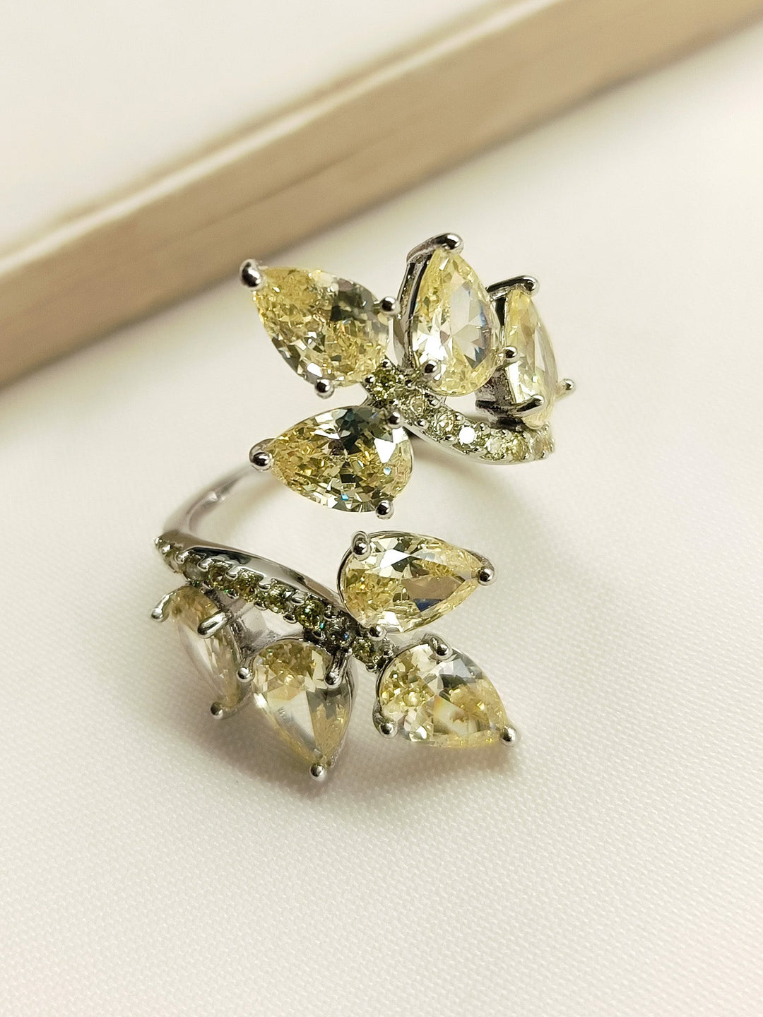 Shimmering Prity Yellow American Diamond Finger Ring with intricate design and sparkling stones