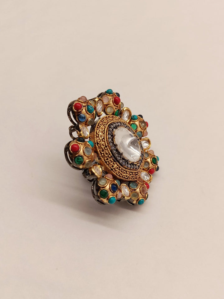 Shelly Victorian Navratna Finger Ring: A beautiful gold ring adorned with nine different gemstones in a vintage-inspired design