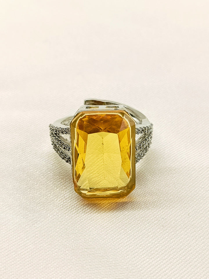  Elegant and stylish Lucy Yellow American Diamond Finger Ring on a woman's finger, showcasing its exquisite design and sparkling yellow diamond