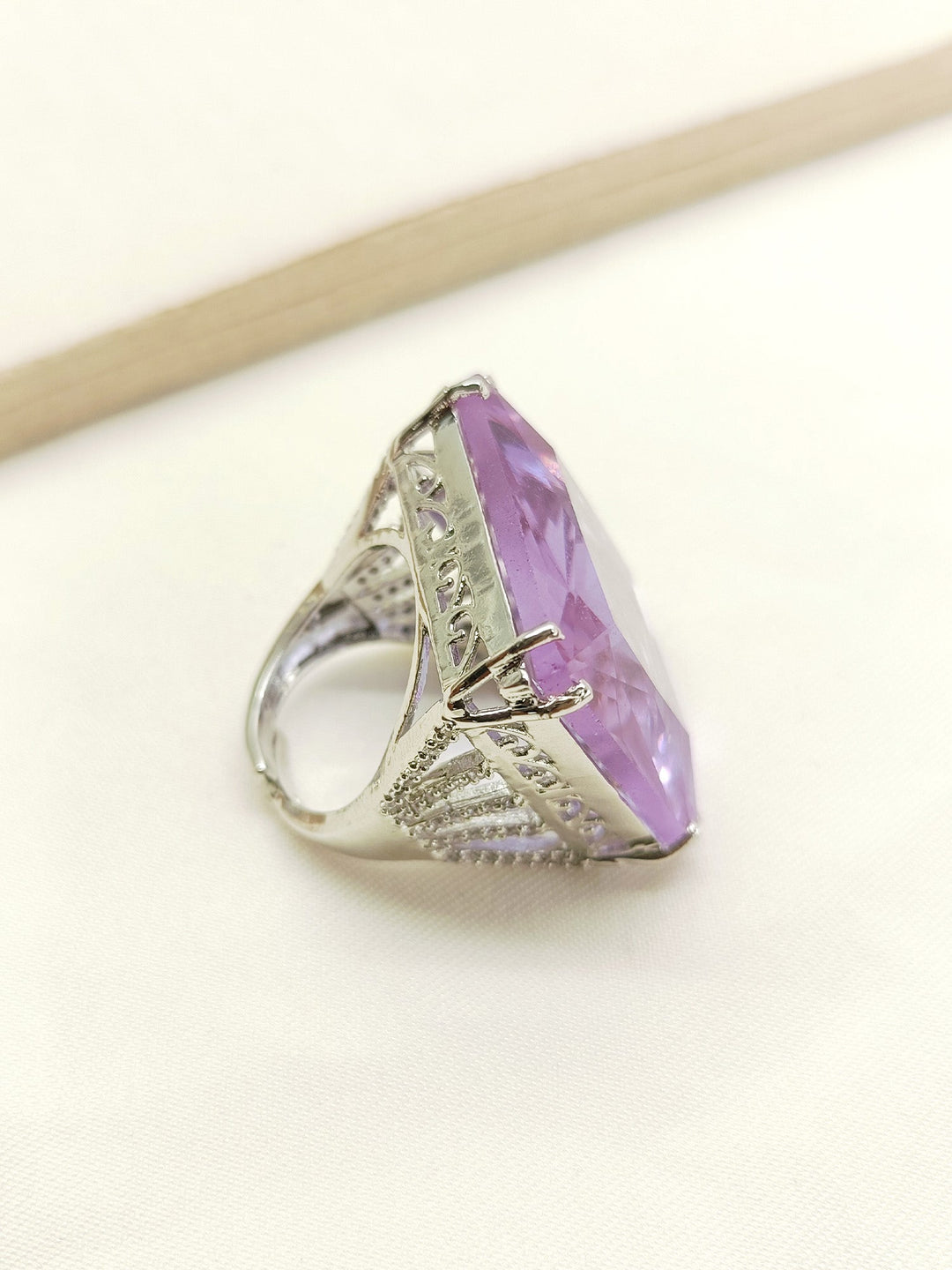  Ireland Lavendar American Diamond Finger Ring displayed on a velvet cushion, highlighting its beauty and sophistication