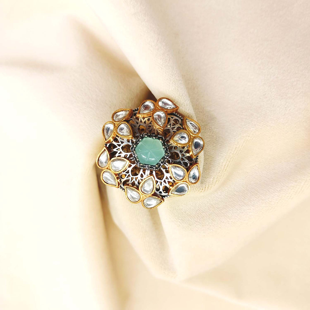 Beautiful Hasina Mint Green Stone Gold Plated Boutique Ring displayed on a velvet cushion, highlighting its exquisite craftsmanship