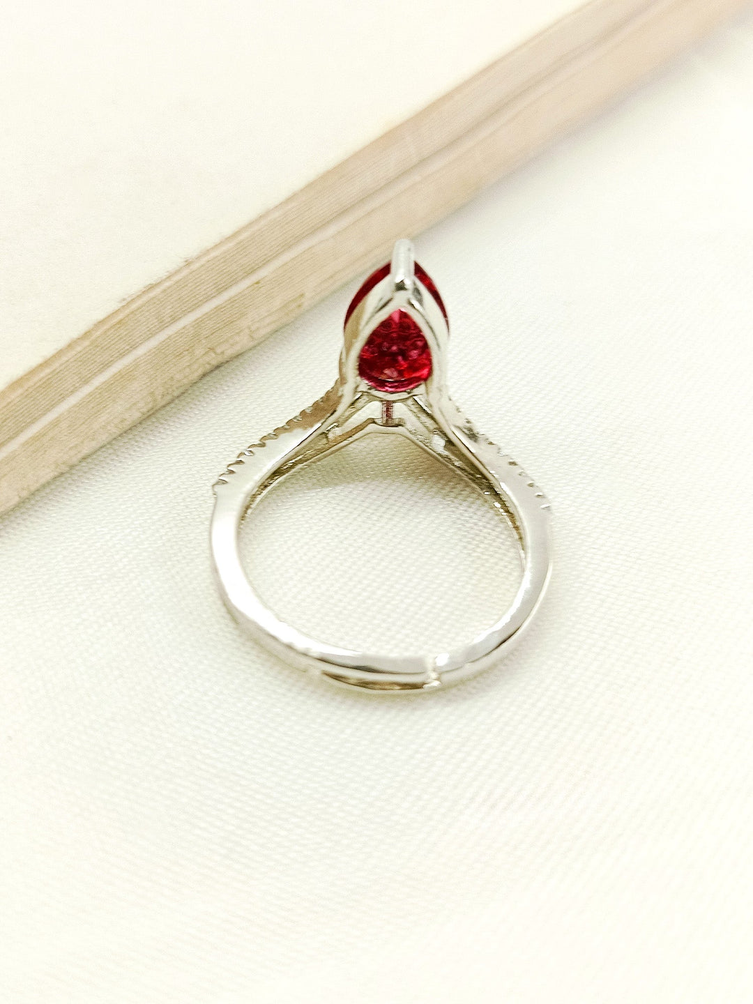  Elegant Zufra Maroon American Diamond Finger Ring on a woman's hand, catching the light