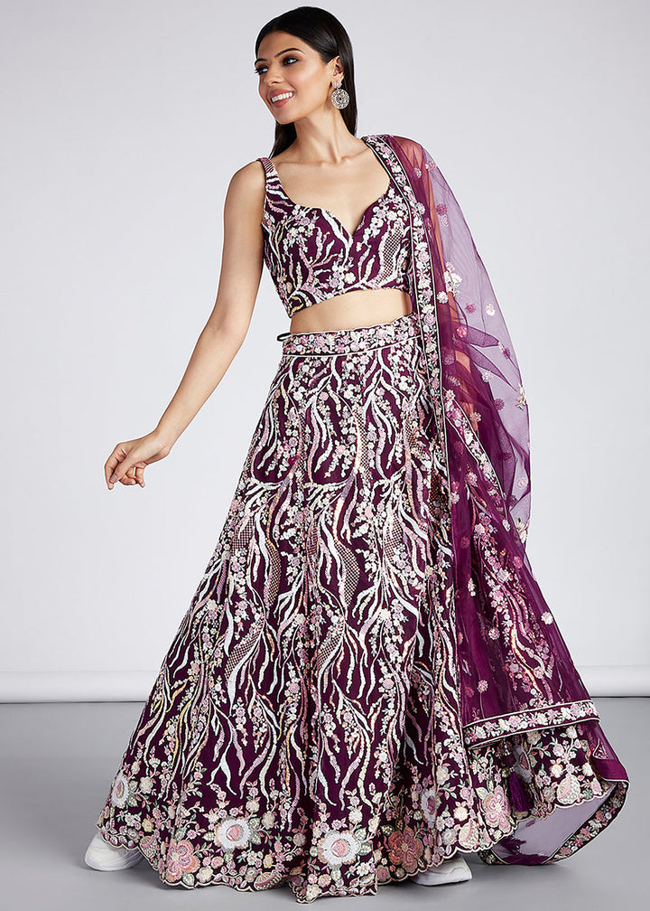 Tyrian Purple Net Lehenga Choli With Sequins & Thread Embroidery Work outfit showcased in traditional wedding setting with intricate embroidery details