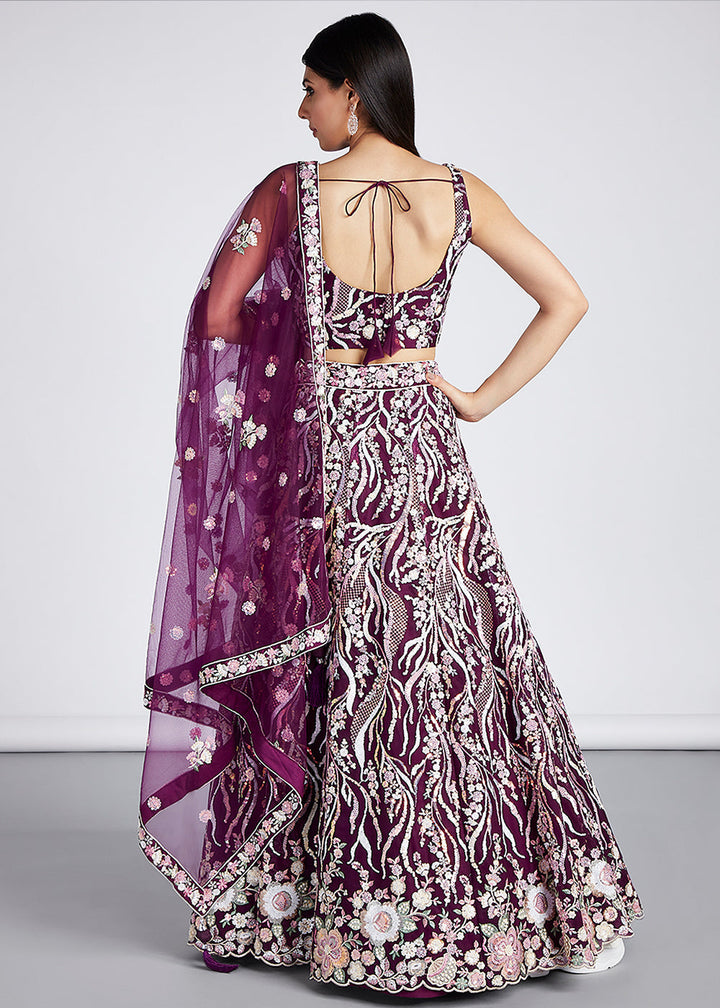 Side view of the flowing net Lehenga in Tyrian Purple with intricate sequins and thread embroidery